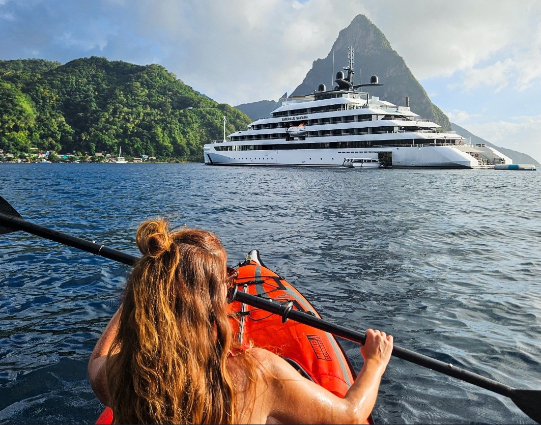woman kayaking near cruise ship